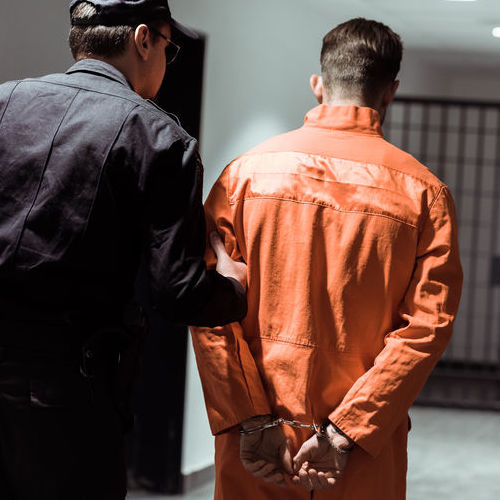 An Inmate Being Led to His Cell.