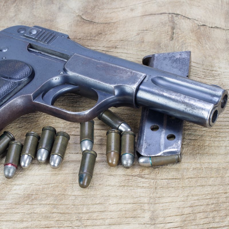 close-up of an old handgun and bullets