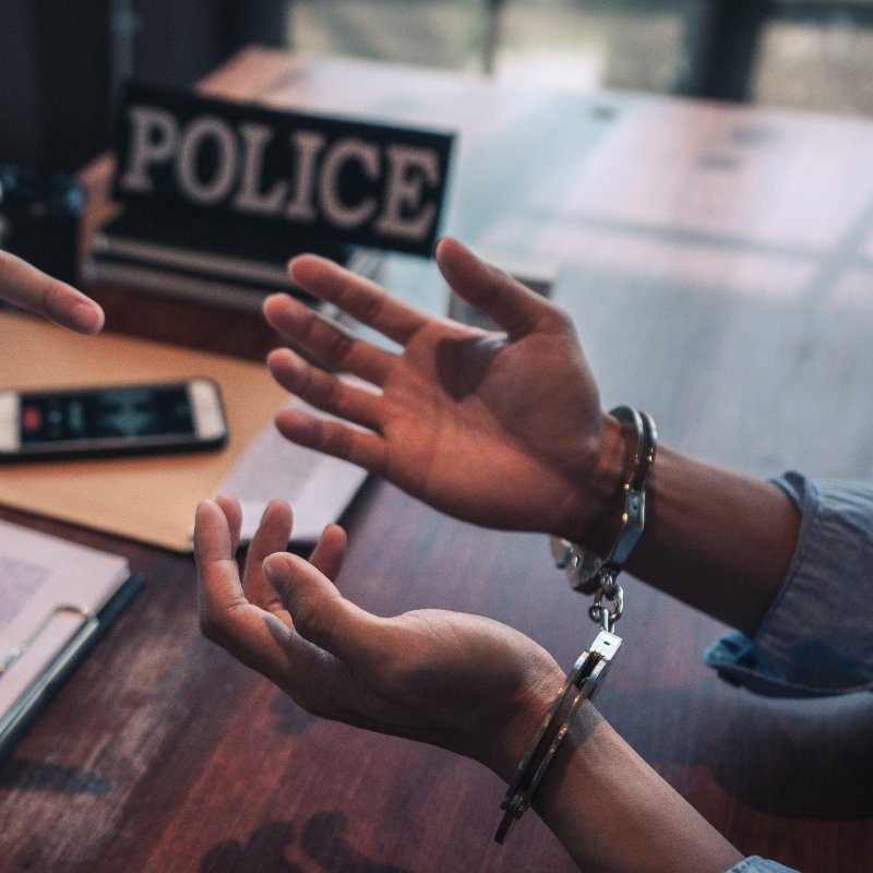 close-up of a man's handcuffed wrists