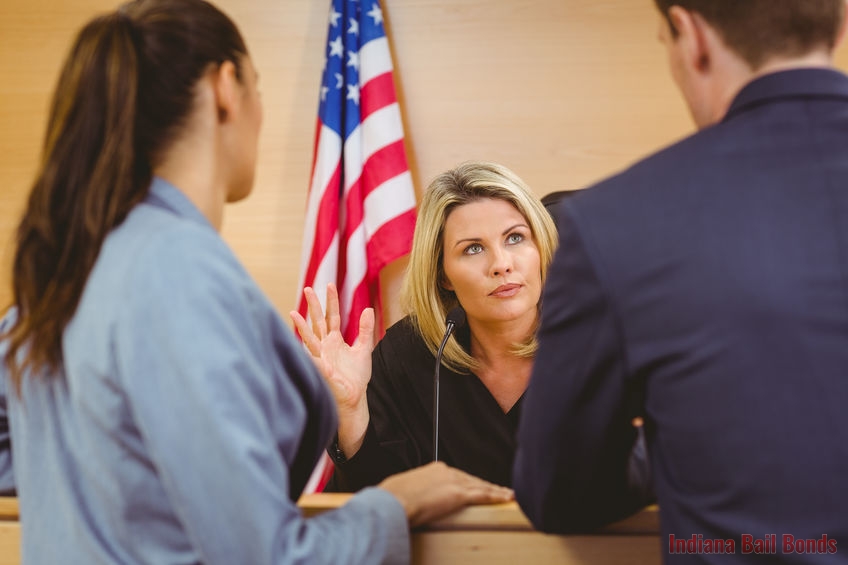 A Picture of a Judge Talking to Two People in Court.