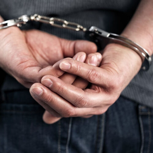 Man in Handcuffs after Parole Violation